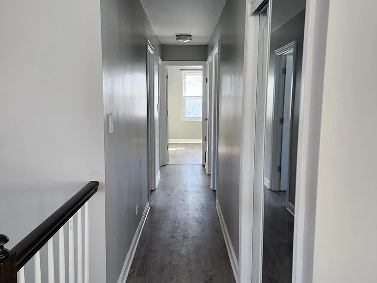 Second Floor: Hallway to 4 bedrooms with coat closet to the right.
