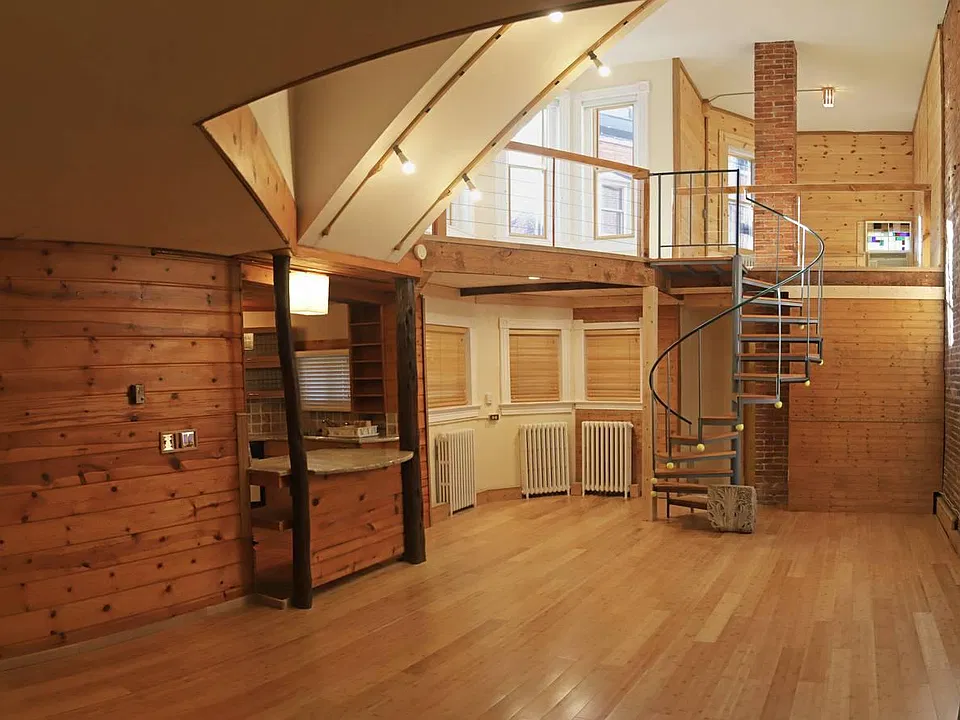 Shows 2 stories of apartment, spiral stairs.