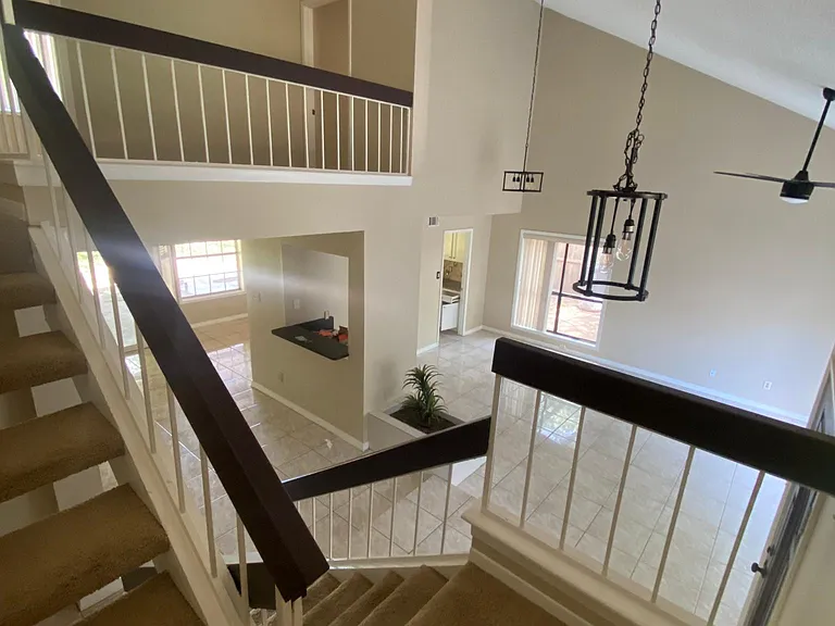 View from staircase looking down to living and family areas