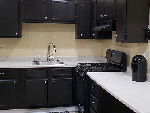 Modern kitchen with tile floor and newer appliances