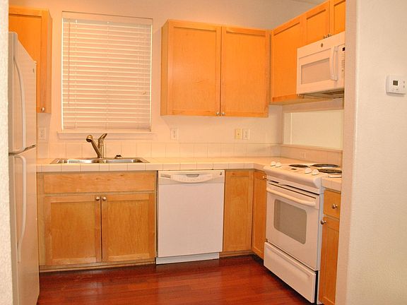 Kitchen with refrigerator, and all necessary appliances.