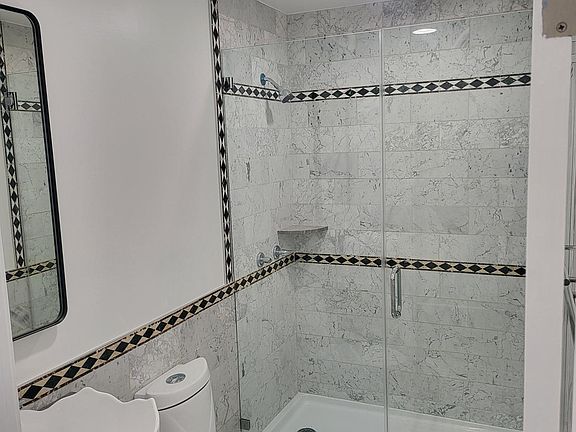 Downstairs hallway guest bathroom fully remodeled.