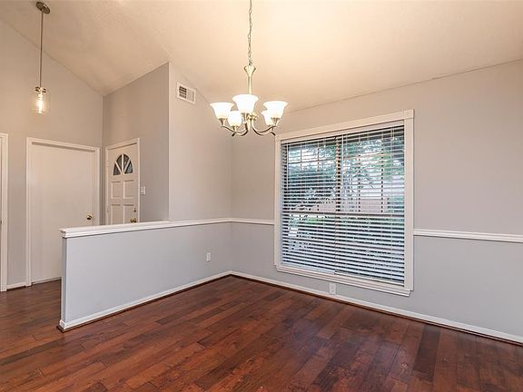 To the left of the front door is the formal dining area complete with chair rail molding, a nice chandelier and 2 inch blinds on the front window.