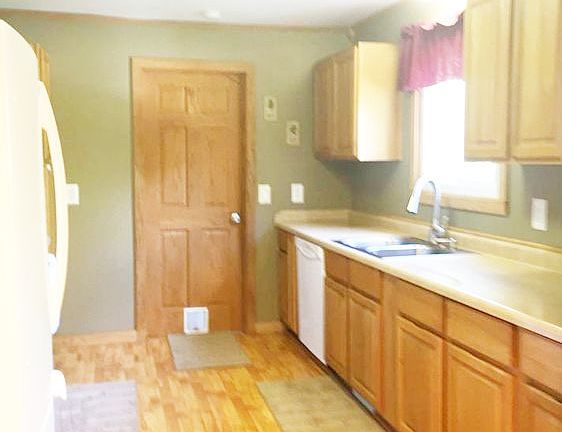 The appliances are also newer and will be staying with the home. Over the sink is a window that will