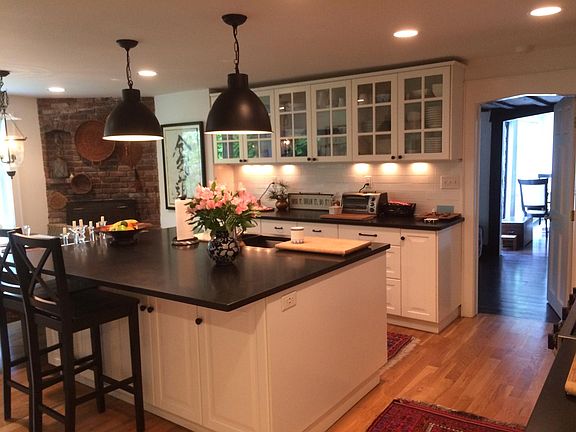 Kitchen with Granite Counters, Center Island with seating, plenty of upper and lower cabinets and separate pantry with sink, counter top and cabinetry.