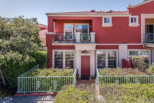 Front elevation of home showcases large picture windows and upstairs Master Bedroom balcony.