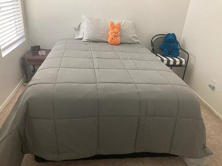 Side table, chair, bed, clock.