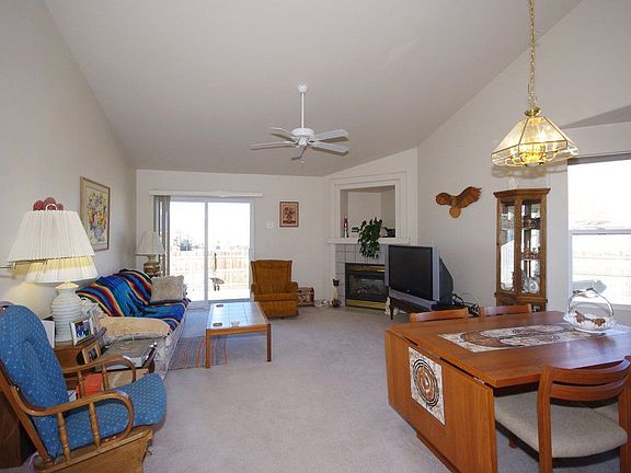 The other half of the LR/DR with gas log fireplace, walk-out to deck, vaulted