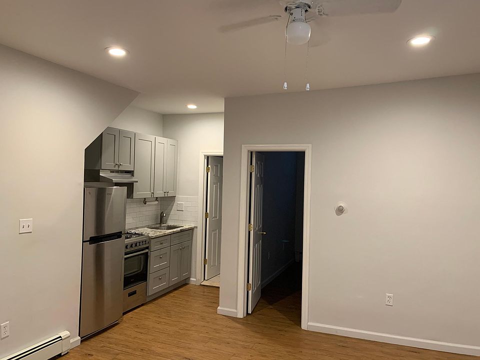 Living Room with the view of the kitchen with stainless steel appliances