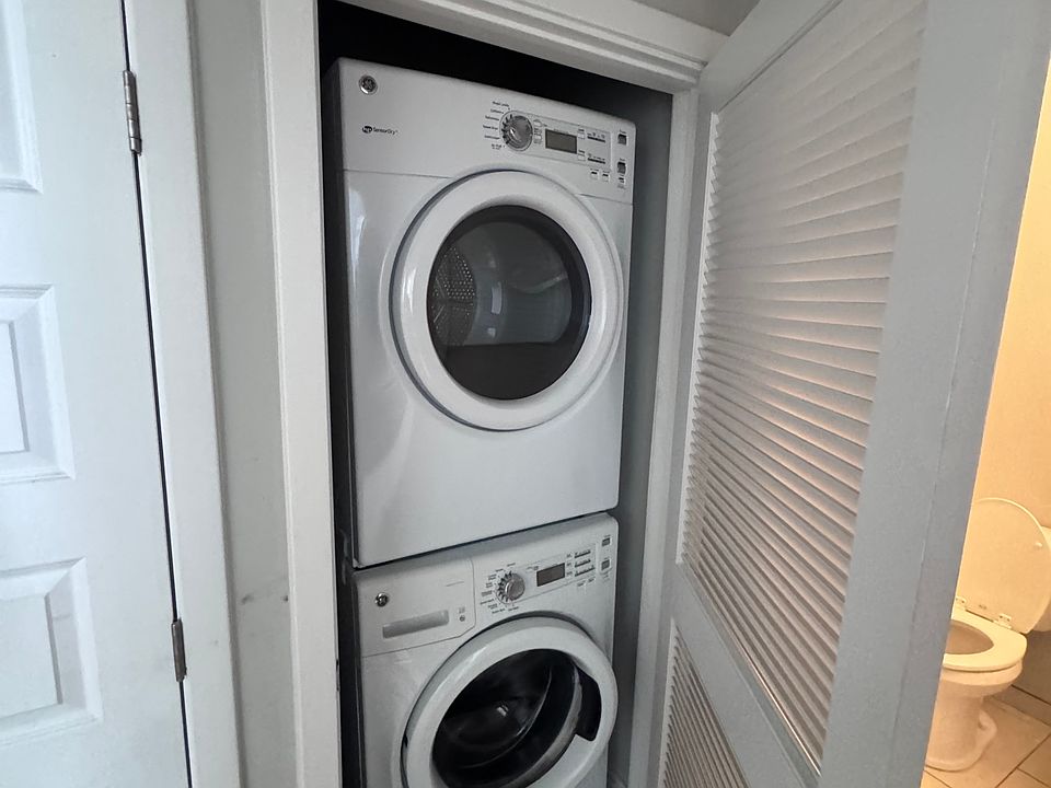 Washer/Dryer outside of bathroom in hallway.