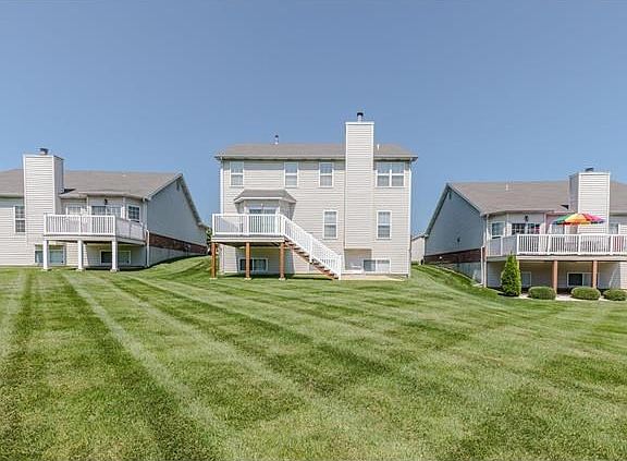 View of spacious backyard and nice deck with stairs leading to a spacious patio perfecting for enter