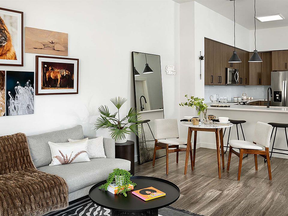 Apartment Kitchen with Stainless Steel Appliances, Dining and Living Room with wood flooring..