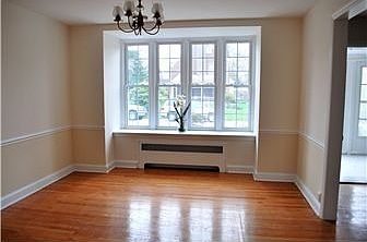 Sunny dining room with chair rail & chandelier