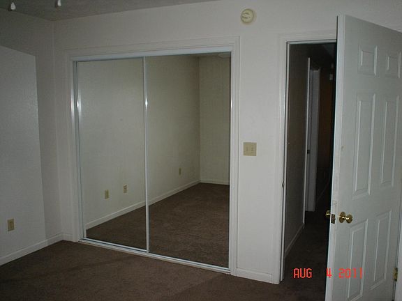 BEDROOM WITH 8FT WIDE CLOSET WITH BUILT IN CLOTHES ROD AND SHELVING.