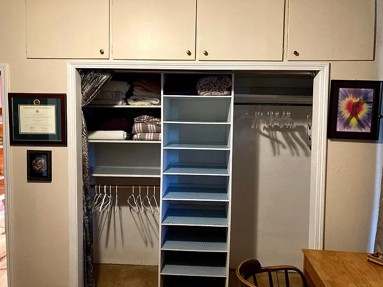 Close up of the closet, shelves and the large storage area above the closet.