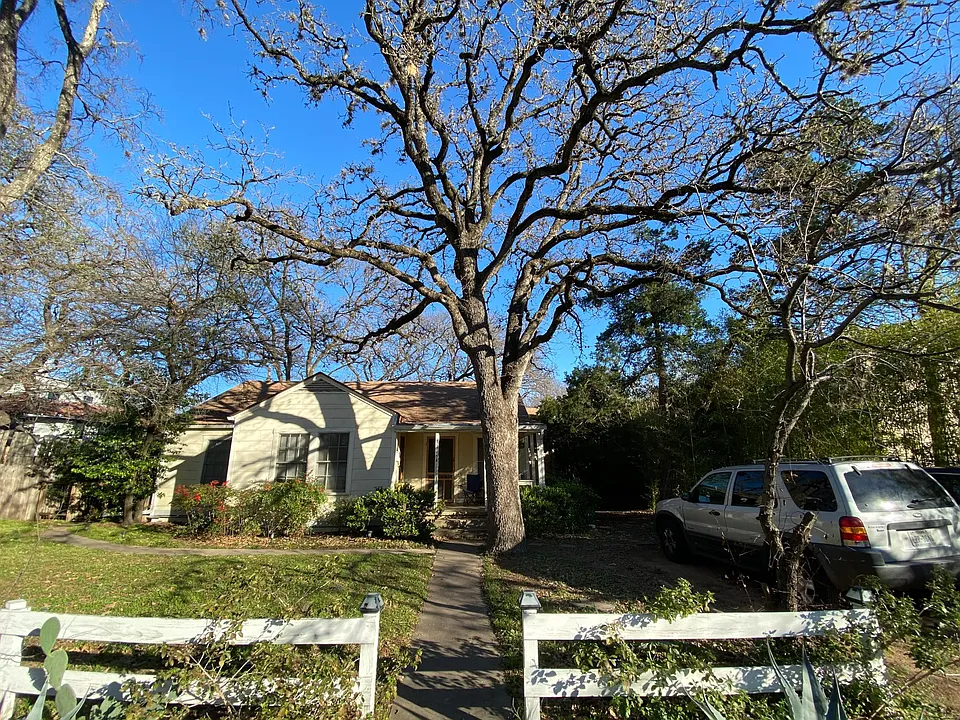 Front of House with driveway parking on side of house