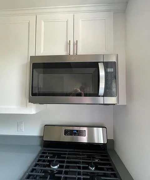 New stainless 5 burner gas stove with new stainless microwave
