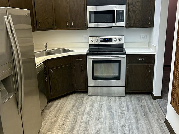 Kitchen with all new stove, microwave, dishwasher, refrigerator has ice maker. New flooring and lighting above will all be white.