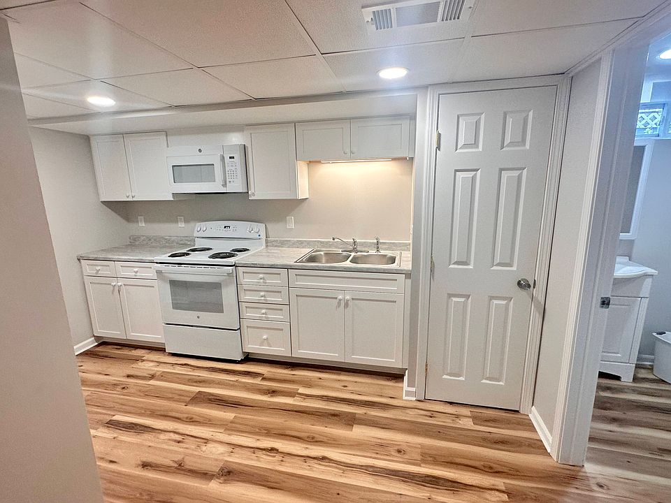 Kitchen includes electric range, microwave and refrigerator (not shown)