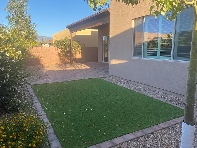 North / South exposure provides a wonderful experience outside. With Turf and expansive paver patio.