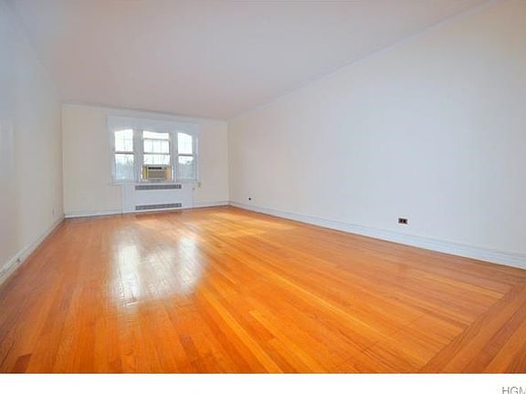 Large sunny living room has southern exposures and hardwood floors.  The room is 23'-0" x 13'-6".
