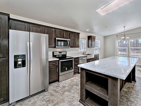 Kitchen - Solid wood cabinets, upgraded stainless appliance package, upgraded nickel hardware, large kitchen island, title back splashes, country farm sink, skylight, recessed lighting.
