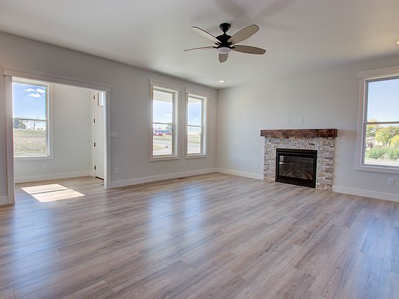 The front entry vestibule with a coat closet and a drop zone opens to the living room