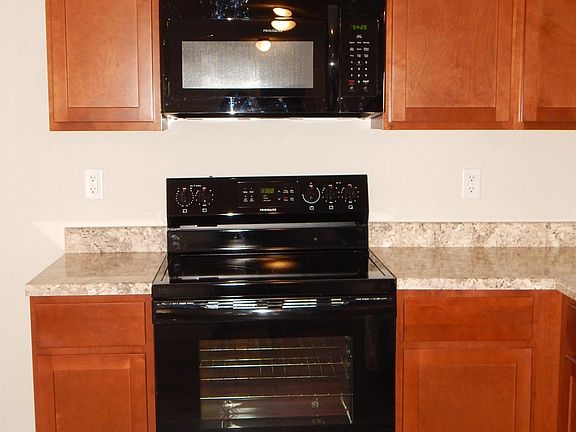 Great kitchen with built in microwave over the smooth top electric stove.