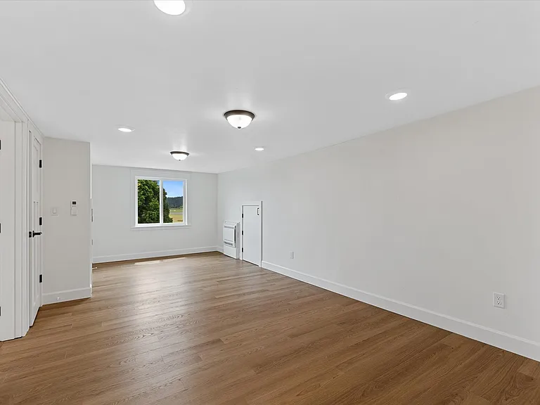Upper (2nd) primary suite w/ 2 closets and 2 attic rooms. Bay and farmland views from end nook.