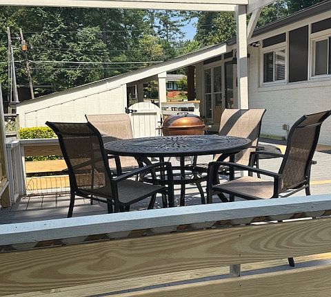 Sun Shade Pergola with Comfy Outdoor Table and Chairs For Private Dining Al Fresco with Weber Barbecue Grill.