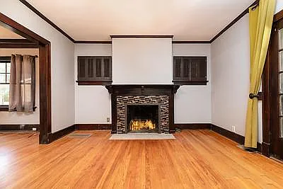 Fireplace and mantel. Space to hang TV over fireplace. Curtains.