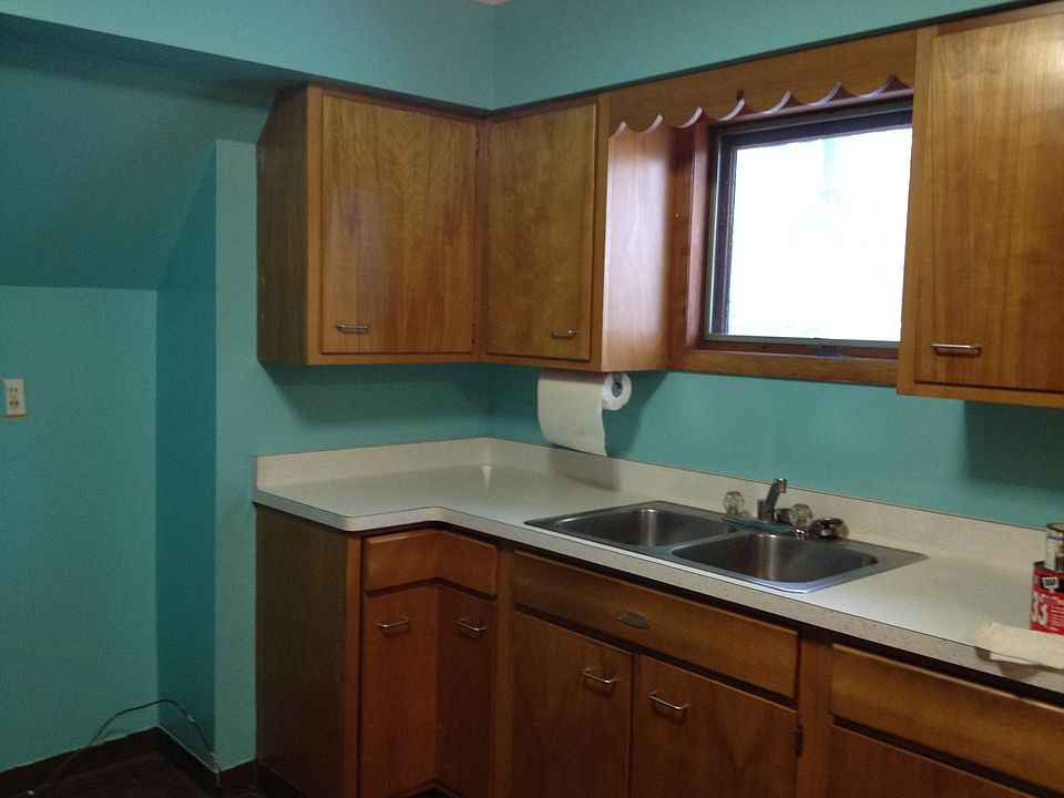 large kitchen with eat in area, double sink, ample cupboards, lazy susan, and counter space