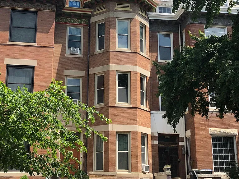 View of beautiful brownstone building from the street. Apt 1 on first level.