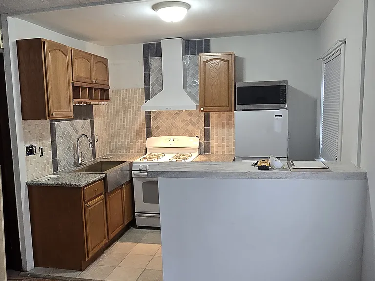 Newly updated granite countertops, sink, range hood, and backsplash.