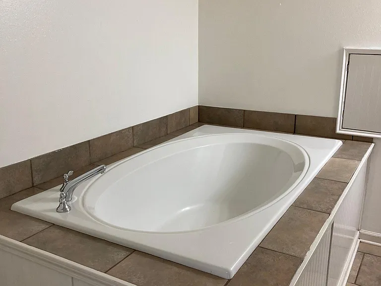 Master bath features large soaking tub and Laundry chute