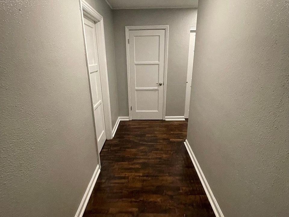 Hallway from the front door of the apartment. To the left is the office and straight ahead is a hallway coat closet