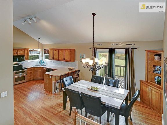 The spacious kitchen and dining room feature a vaulted ceiling, breakfast bar and built-in hutch.