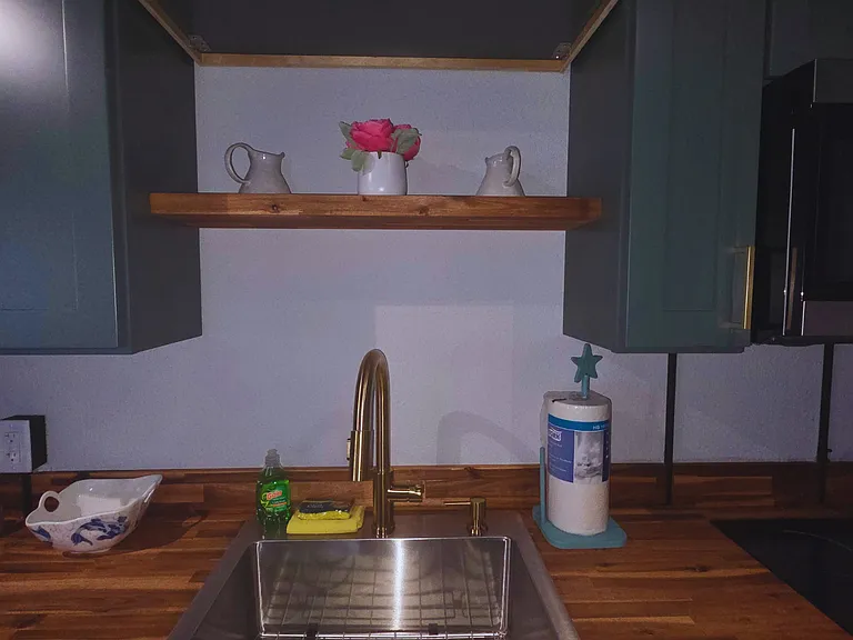 Modern sink area with elegant decor and full essentials for a comfortable stay.