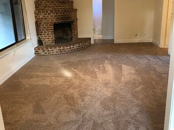 Living room with corner fireplace.