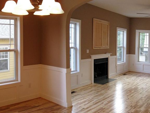 Wood floors, high ceilings, and a fireplace in the living room.