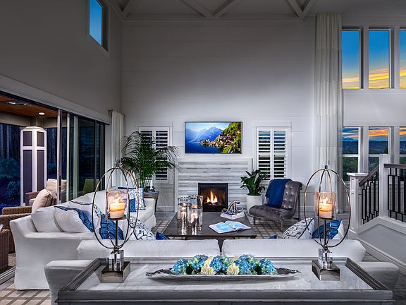 Soaring two-story ceiling floods the family room with light