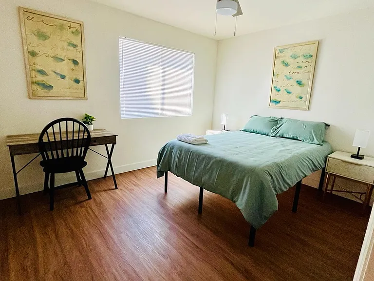 full bed, two night stands, and work space