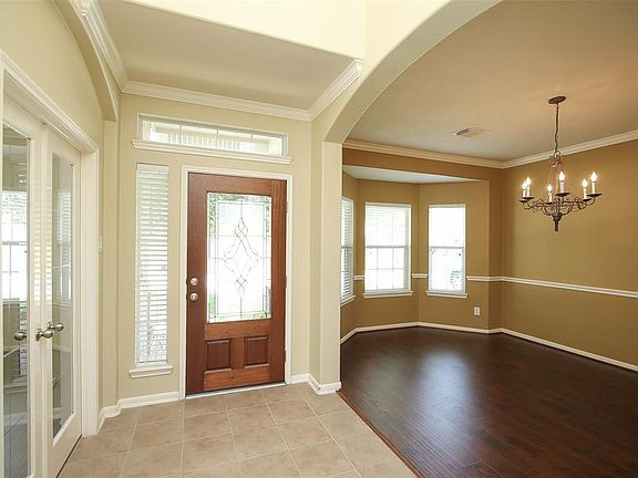 To the right of the tiled entry is a study with french doors and to the left is a spacious formal dining room.
