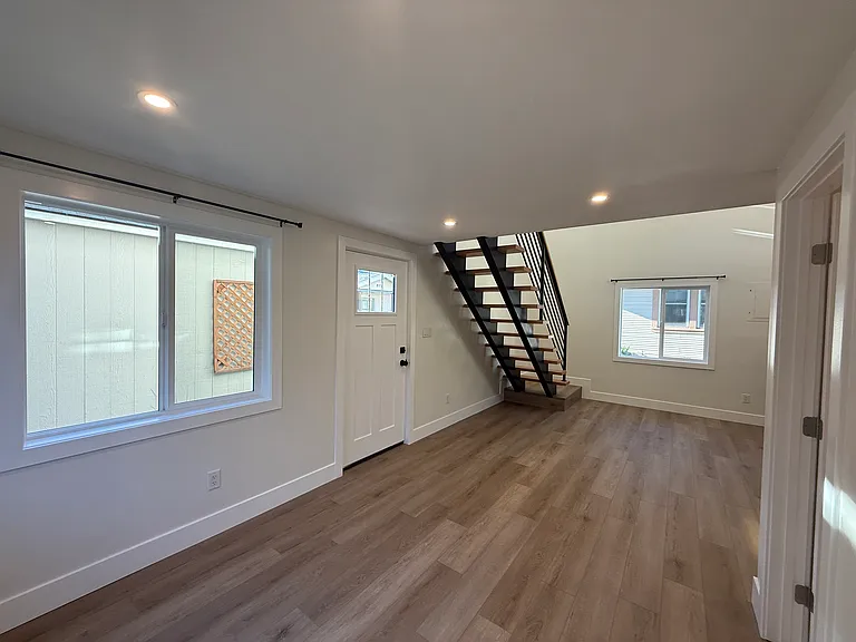 living space looking toward kitchen/dining area and stairs