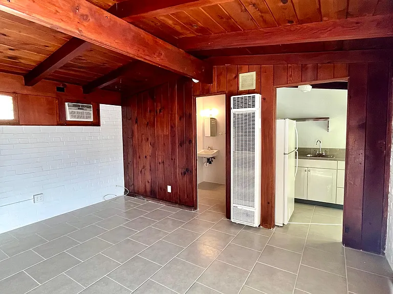 Perspective from living area into bath and kitchen.