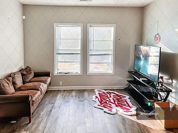 Livingroom w/plenty of natural light! Photo is of current tenants decor. Will be updated!!