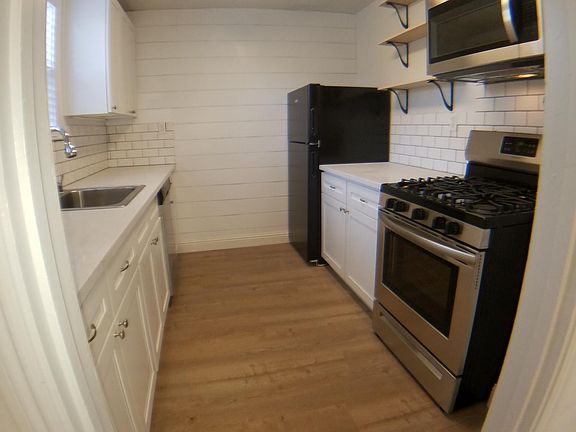 Quality white quartz countertop, easy dishwasher, food storage for the family, 5 burner gas stove for entertaining guests, highly efficient microwave, soft close cabinets and ample open shelvings.