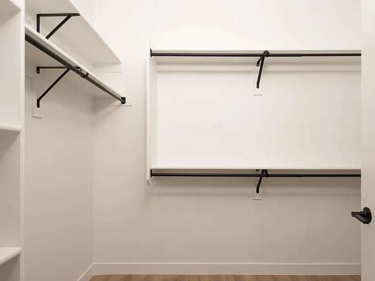 Oversized closet with built-in shelving and double hanging rods_designed to keep your wardrobe organized and within reach.
