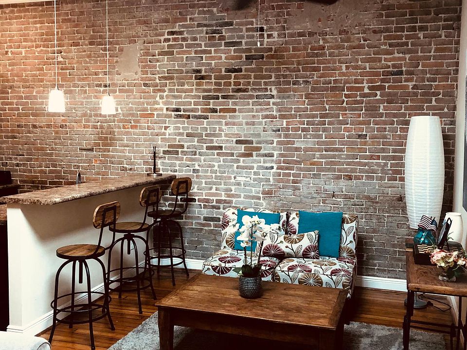 Furnished unit, orignal brick and hardwood floors