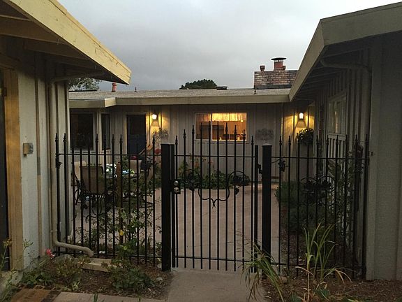 Looking into court yard w/ Iron Fence and Gate